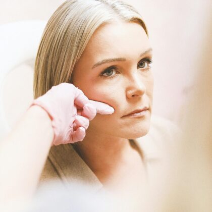 Close-up of a woman receiving a cosmetic injection at a modern beauty clinic.