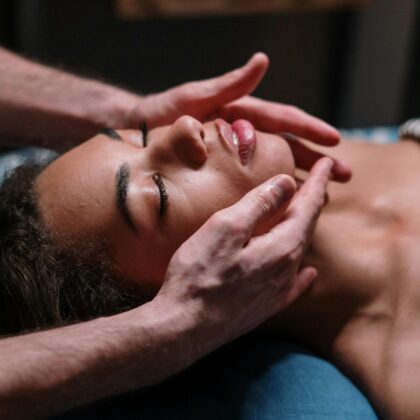 Close-up of a woman receiving a soothing facial massage in a serene spa environment.